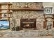 Stone fireplace with wooden mantle and built-in shelves at 840 2Nd St, Clermont, FL 34711