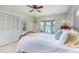 Bright bedroom featuring a large bay window with serene water views, ceiling fan, and ample closet space at 840 2Nd St, Clermont, FL 34711