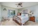 Bright bedroom featuring a large bay window with serene water views, ceiling fan, and ample closet space at 840 2Nd St, Clermont, FL 34711