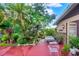 Charming patio area with lush greenery and comfortable seating, ideal for relaxing and entertaining outdoors at 840 2Nd St, Clermont, FL 34711