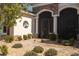 The home's entrance features a brick walkway, decorative shrubs, and a decorative metal tree at 8682 Bridgeport Bay Cir, Mount Dora, FL 32757