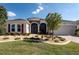 Charming single-story home features brick driveway and beautiful landscaping at 8682 Bridgeport Bay Cir, Mount Dora, FL 32757