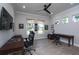 Spacious home office featuring two desks, comfortable chairs, and natural light at 8682 Bridgeport Bay Cir, Mount Dora, FL 32757