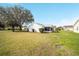 Expansive backyard with lush green grass surrounding the home at 901 Chula Ct, The Villages, FL 32159