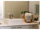 Bathroom features a contemporary sink, quartz countertop, modern faucet, and decorative basket at 901 Chula Ct, The Villages, FL 32159