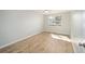 Bright bedroom featuring wood-look floors, a ceiling fan, and large window at 901 Chula Ct, The Villages, FL 32159