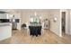 Sunlit dining area adjacent to the kitchen with wood floors and backyard view at 901 Chula Ct, The Villages, FL 32159