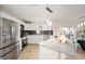 Bright kitchen featuring stainless steel appliances, granite countertops, white cabinetry, and modern pendant lighting at 901 Chula Ct, The Villages, FL 32159