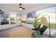 Bright sunroom with neutral rug, ceiling fan, large windows, and comfortable seating at 901 Chula Ct, The Villages, FL 32159