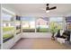 Bright sunroom with neutral rug, ceiling fan, and many windows showcasing the landscape at 901 Chula Ct, The Villages, FL 32159