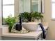 Close up of vanity with vessel sink, greenery, and modern fixtures at 901 Chula Ct, The Villages, FL 32159