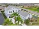 Aerial view of a well-manicured property featuring lush landscaping, ample parking, and a three-car garage at 977 Timberview Rd, Clermont, FL 34715