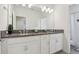 Bathroom featuring a double vanity, granite countertop, white cabinets, and a shower with a stylish curtain at 977 Timberview Rd, Clermont, FL 34715