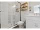 Modern bathroom with glass-enclosed shower, white vanity and shelving for storage at 977 Timberview Rd, Clermont, FL 34715