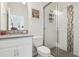 Modern bathroom featuring a glass shower, white vanity, and contemporary fixtures at 977 Timberview Rd, Clermont, FL 34715