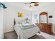 Bright bedroom with a comfortable bed, wooden furniture, and a ceiling fan at 977 Timberview Rd, Clermont, FL 34715