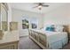 Bright bedroom features stylish decor, including a decorative bedframe, dresser, and a ceiling fan at 977 Timberview Rd, Clermont, FL 34715