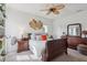 Cozy bedroom features a comfortable bed, ceiling fan, and dresser at 977 Timberview Rd, Clermont, FL 34715