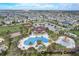 Aerial view of the community center with a pool, playground, and ample parking at 977 Timberview Rd, Clermont, FL 34715