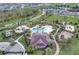 Aerial view of a resort-style community pool with lush landscaping and a splash pad at 977 Timberview Rd, Clermont, FL 34715