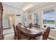 Elegant dining room with a chandelier, large windows, and stylish chairs perfect for entertaining guests at 977 Timberview Rd, Clermont, FL 34715