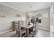 Bright dining room with wood table and chairs, decorative lighting and a large window at 977 Timberview Rd, Clermont, FL 34715