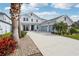 Two story home with a long driveway, three-car garage, and well-manicured landscaping at 977 Timberview Rd, Clermont, FL 34715