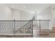 Upstairs hallway features hardwood floors, wrought iron railing and recessed lighting at 977 Timberview Rd, Clermont, FL 34715