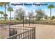 A colorful playground with swings and play structures, set in a well-maintained community park at 977 Timberview Rd, Clermont, FL 34715