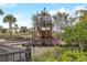 Nautical themed playground with pirate ship, slide, and fencing; surrounded by houses and trees at 977 Timberview Rd, Clermont, FL 34715