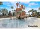 Entertaining pirate themed waterslide feature in pool area with palm trees, slide, and various climbing features at 977 Timberview Rd, Clermont, FL 34715