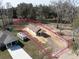 Aerial view of a newly built single-story home with a spacious lot outlined in pink at Lot 15 Indian Estates Cr 423, Lake Panasoffkee, FL 33538