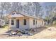 Single-story home with light beige siding and dark trim around the windows and door at Lot 15 Indian Estates Cr 423, Lake Panasoffkee, FL 33538