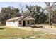 Newly constructed single-story home with board siding and a small covered porch at Lot 15 Indian Estates Cr 423, Lake Panasoffkee, FL 33538