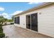 Patio area with sliding glass doors leading to the home's interior at 2277 Whisper St, The Villages, FL 32162