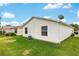 Green backyard with vinyl siding and well-kept lawn at 2277 Whisper St, The Villages, FL 32162