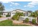 Well-maintained home featuring a white picket fence, manicured lawn, and charming landscaping at 2277 Whisper St, The Villages, FL 32162