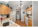 Galley kitchen with white appliances and plenty of counter space and cabinets at 2277 Whisper St, The Villages, FL 32162