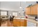 Kitchen with bar seating and views to the living room at 2277 Whisper St, The Villages, FL 32162