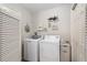 Bright laundry room with modern washer and dryer and practical storage solutions at 2277 Whisper St, The Villages, FL 32162