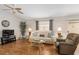 Comfortable living room with ceiling fan and wood-look flooring at 2277 Whisper St, The Villages, FL 32162