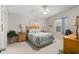 Bright main bedroom with ceiling fan, carpeted floors, and large window at 2277 Whisper St, The Villages, FL 32162