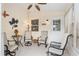 Cozy sunroom with neutral decor, tile flooring, ceiling fan, and comfortable seating at 2277 Whisper St, The Villages, FL 32162