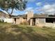 The rear of the home showing outdoor access with a shed and screened porch at 100 W Idlewild Ave, Eustis, FL 32726