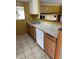 Cozy kitchen with stainless steel sink, white dishwasher, and light countertops at 100 W Idlewild Ave, Eustis, FL 32726