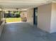 This covered back patio includes a ceiling fan and access to the fenced-in yard at 100 W Idlewild Ave, Eustis, FL 32726