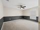 Spacious bedroom featuring neutral tones, carpeted floors, and a ceiling fan at 10230 Barrington Ct, Leesburg, FL 34788