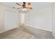 Bedroom featuring neutral walls, carpet, and a ceiling fan for comfort at 10230 Barrington Ct, Leesburg, FL 34788