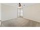 Cozy carpeted bedroom with a ceiling fan and natural light from the windows at 10230 Barrington Ct, Leesburg, FL 34788