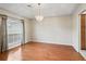 Bright dining room featuring hardwood floors, natural light and a modern chandelier at 10230 Barrington Ct, Leesburg, FL 34788